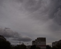 Construction crane and apartment buildings under a cloudy sky