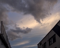 Evening sky with industrial buildings silhouetted against a gradient of sunset colors