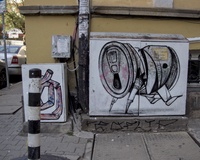 A street electrical box decorated with a picture of a steel drink can represented as a four legged animal